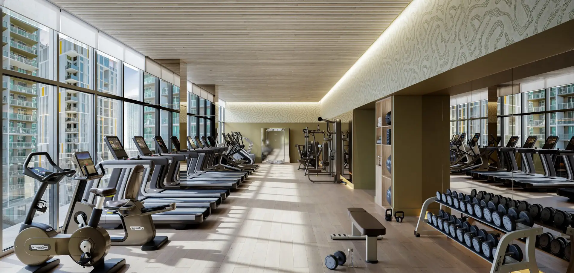 Viceroy Brickell Miami fitness center with treadmills, weight equipment and tall windows